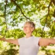 Happy elderly woman with arms outstretched doing a meditation and breathing exercise